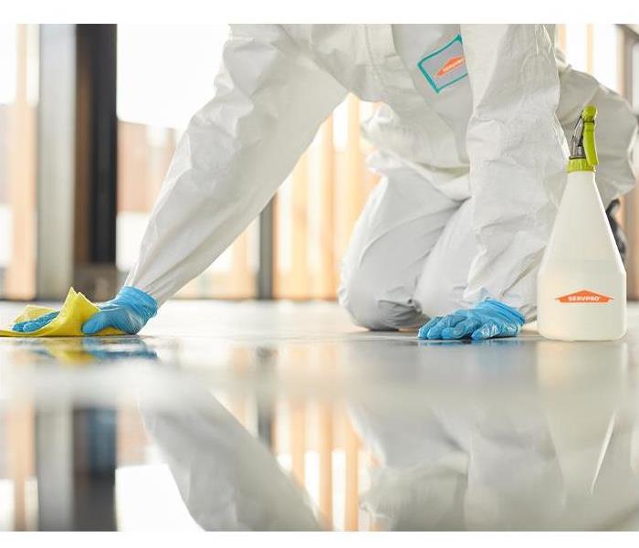 SERVPRO employee disinfecting floor