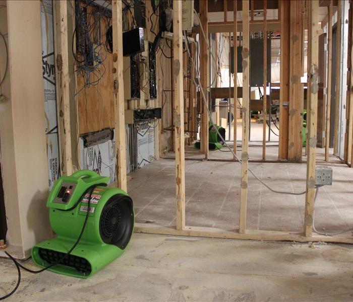 Construction site with a air mover on the ground.