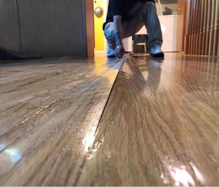 Warped hardwood floors from water damage.
