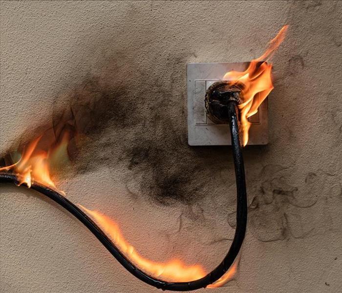 Cord in outlet on fire.